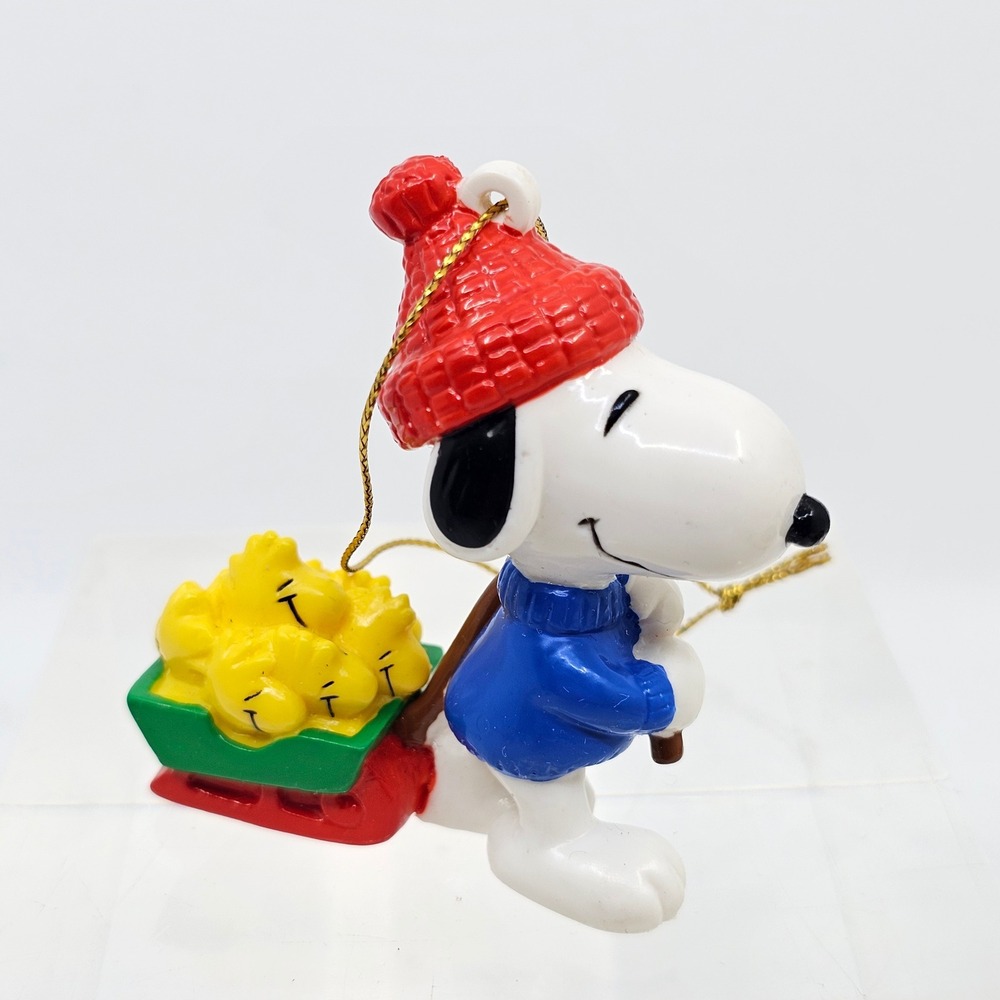 Snoopy Pulling Woodstocks Christmas Ornament. Peanuts. United Feature Syndicate
